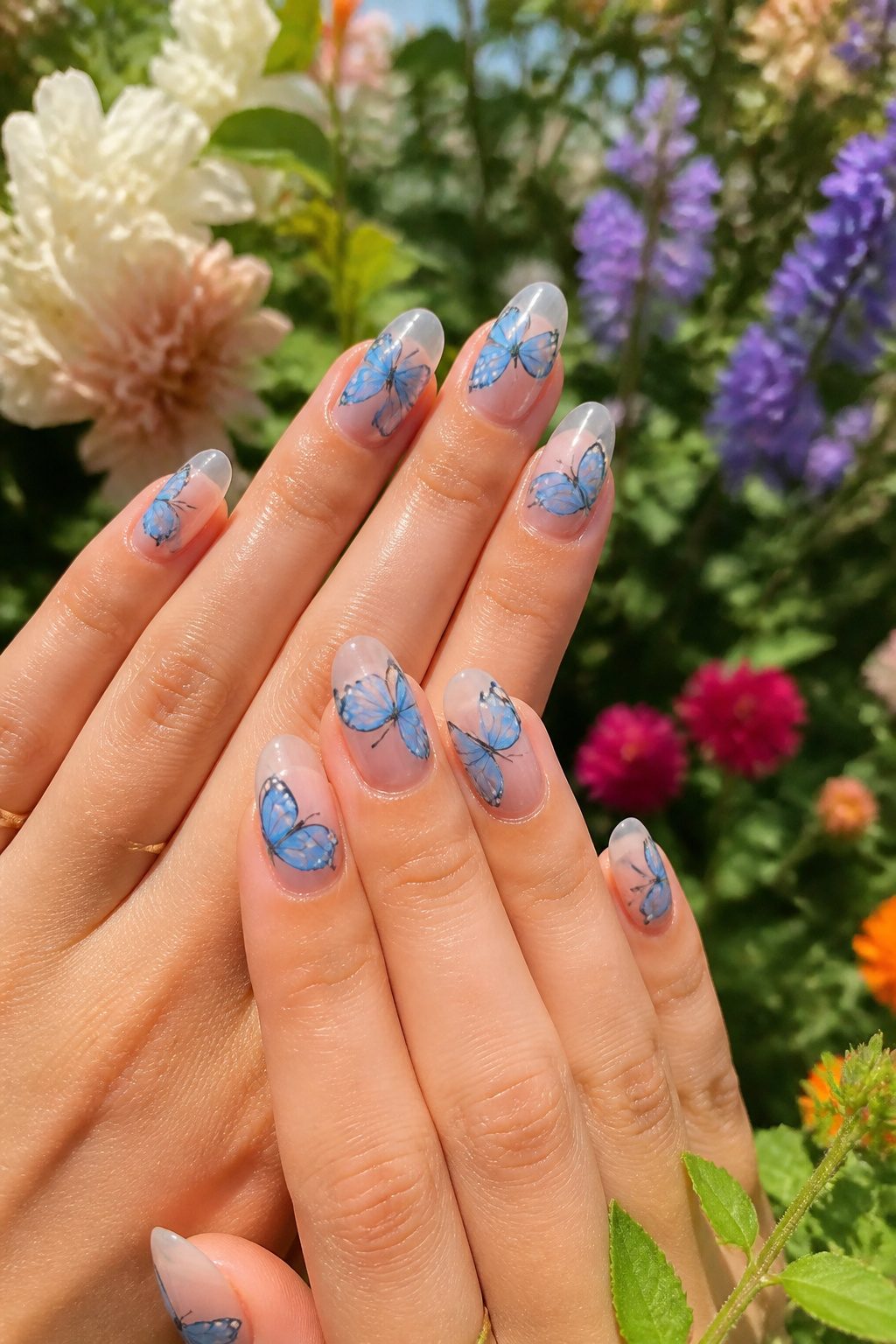 Nail art featuring blue butterfly designs.