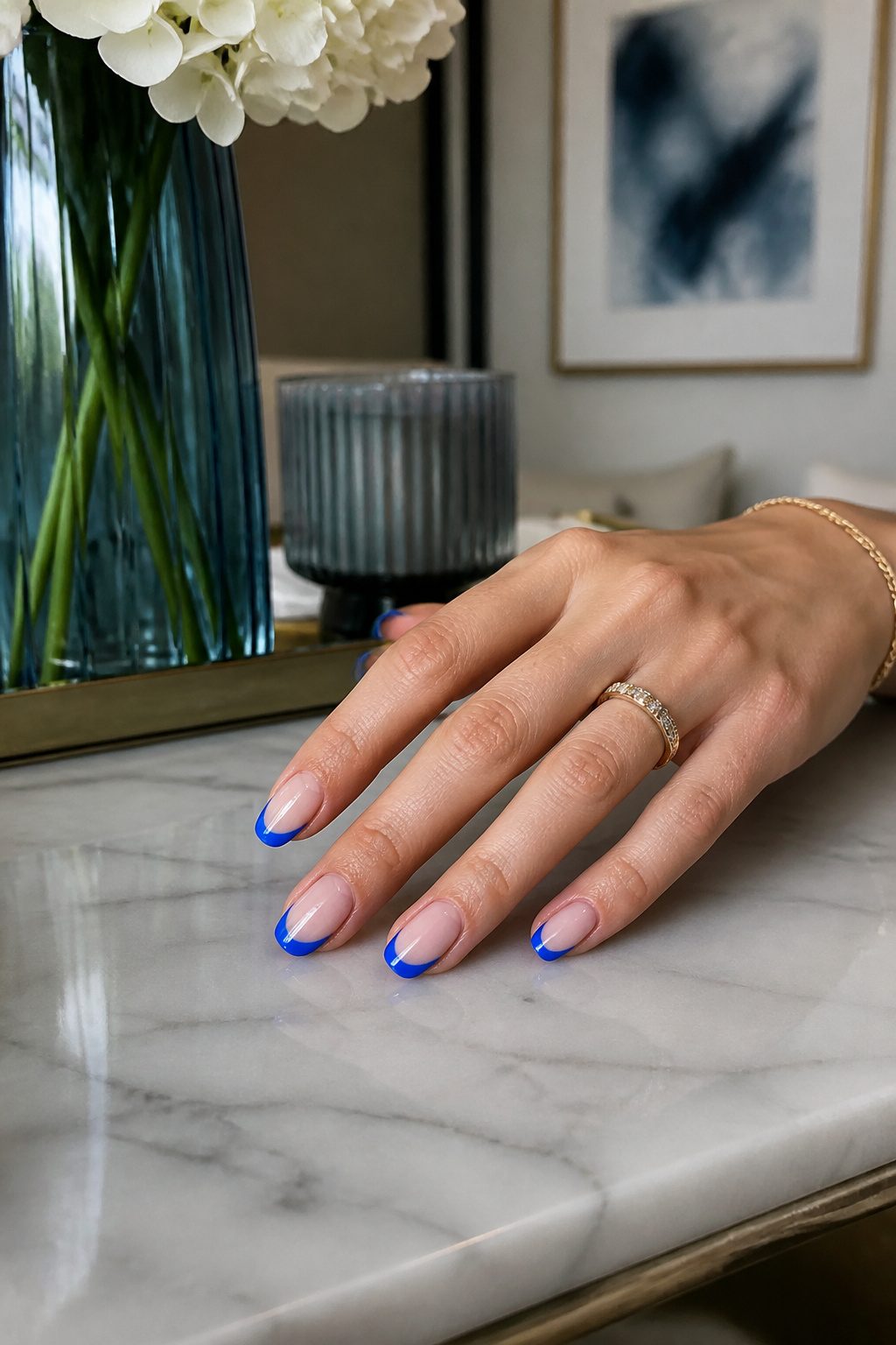 Nails with blue French tips over a sheer pink base.