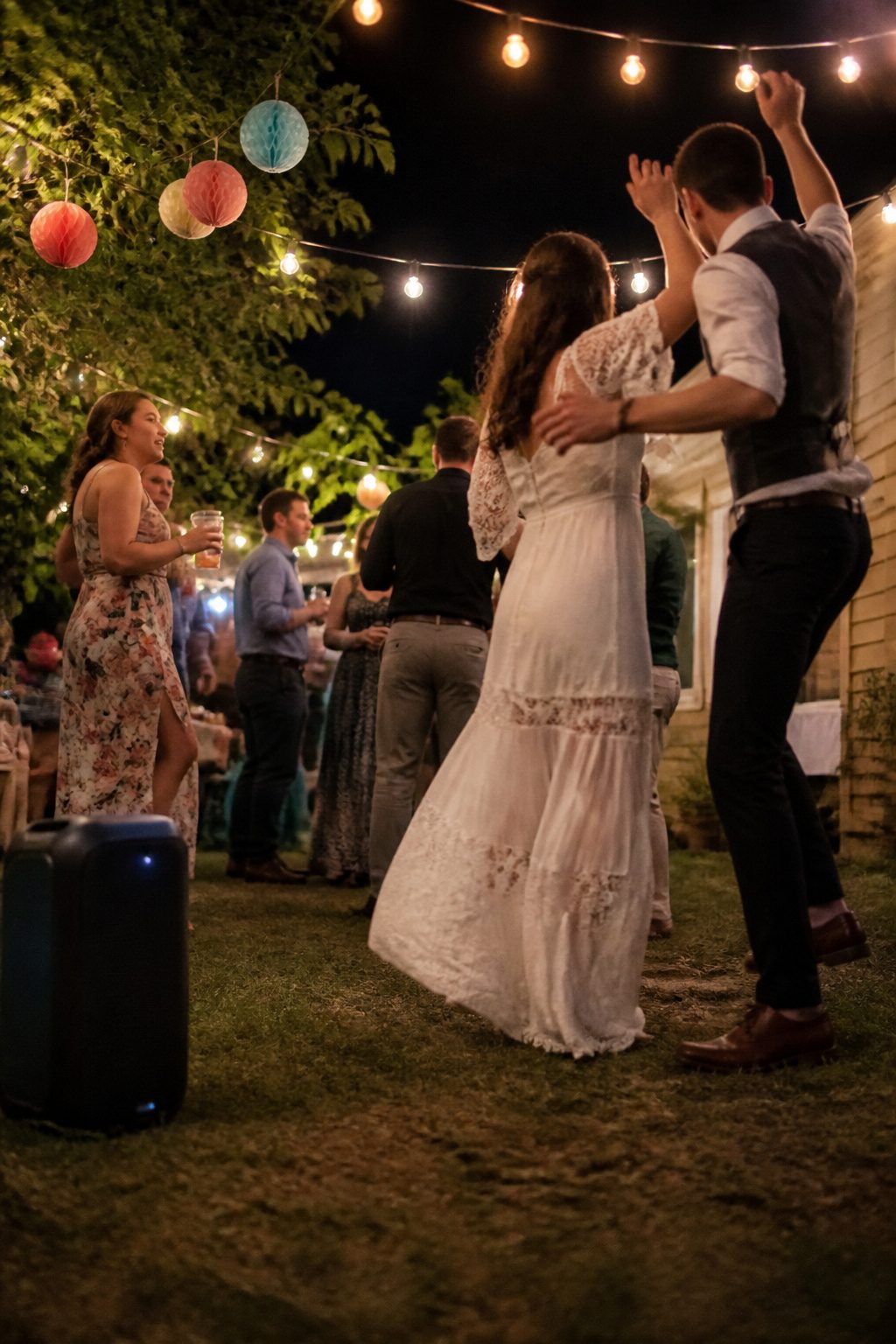 A Bluetooth speaker set up for music at a wedding reception.