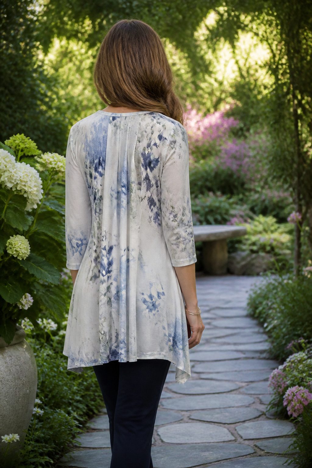 How to Dress for Your Body Type: A Practical 7-Shape Guide for 2026 10 A model in a garden wears a flowy tunic that hits mid-hip.
