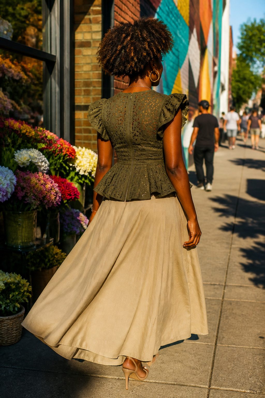 How to Dress for Your Body Type: A Practical 7-Shape Guide for 2026 5 A model poses in a peplum top and flared skirt on a city street.
