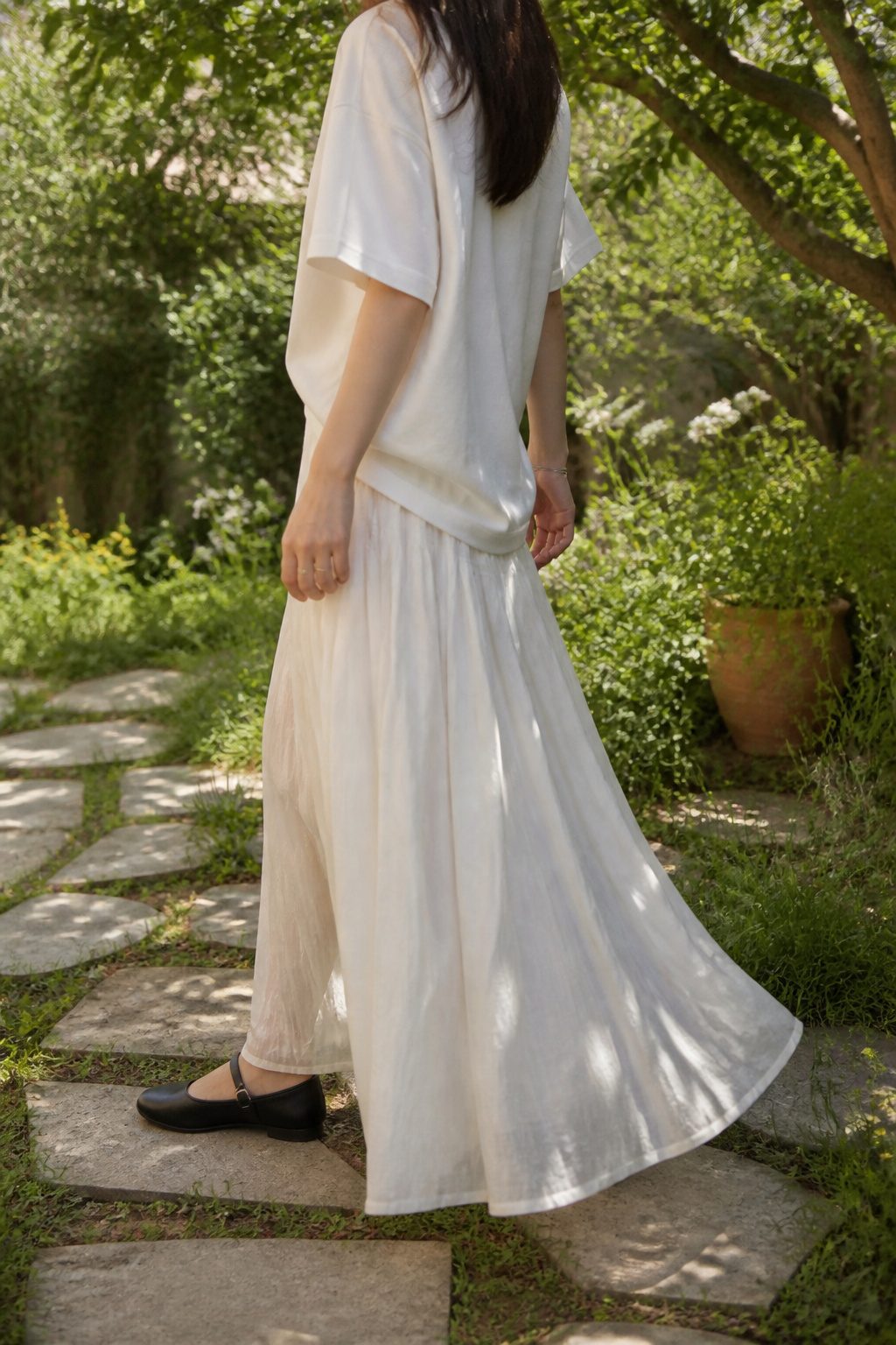 20 Mary Jane Shoes Outfit Ideas for Easy Spring 2026 Style 3 Model wearing an oversized t-shirt and a flowing maxi skirt with Mary Janes.