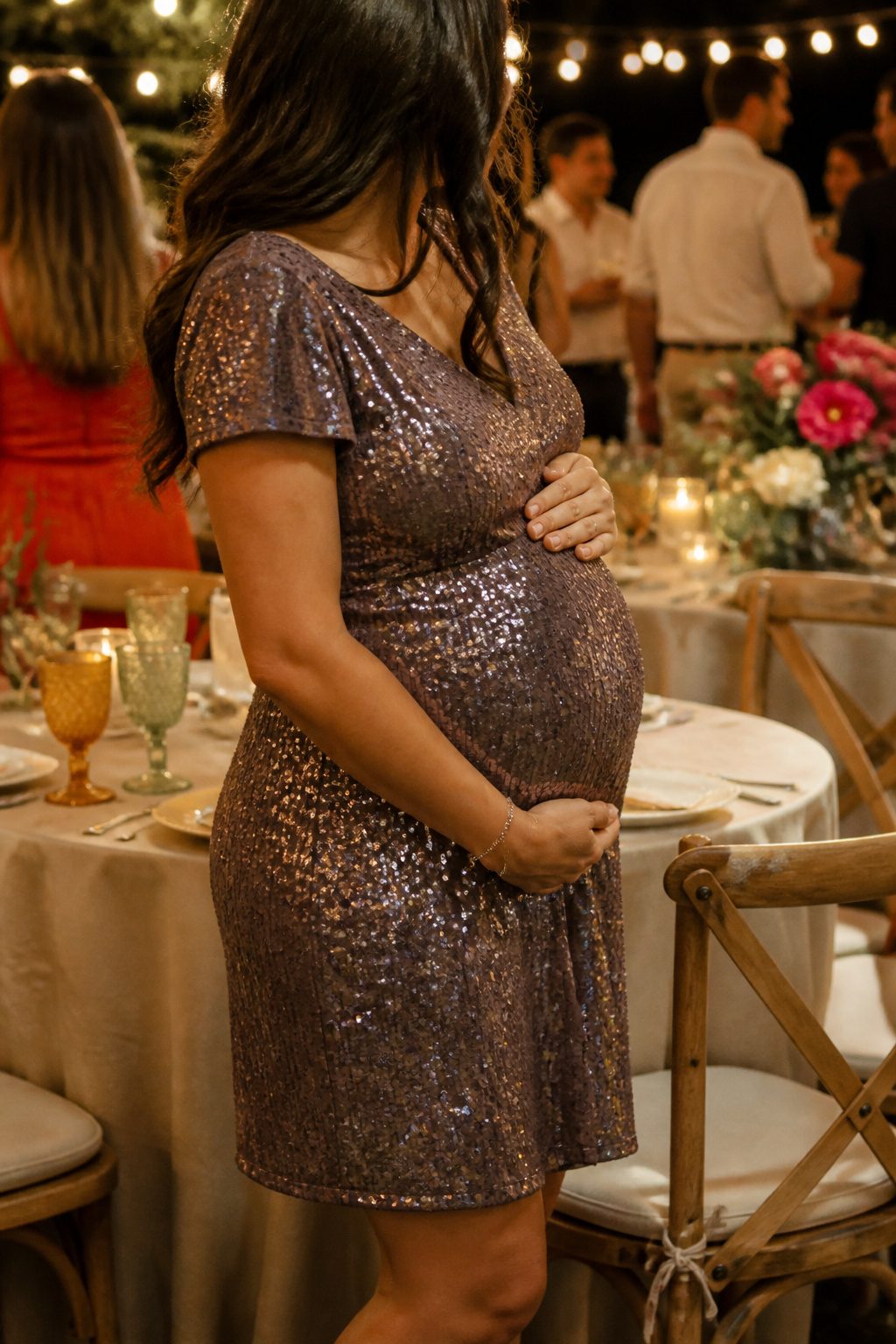 Expectant mother in a sequin party dress at an evening gathering.