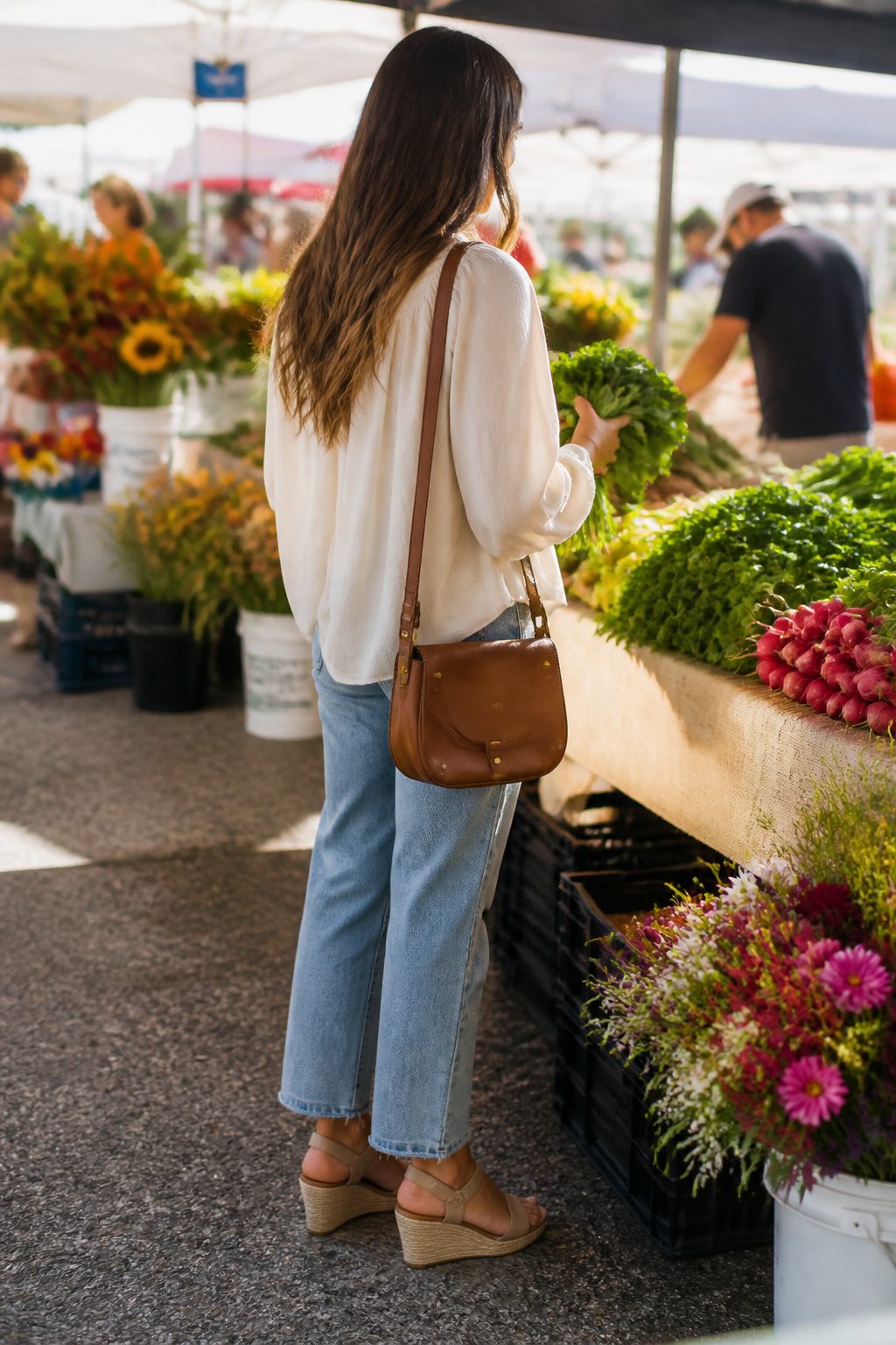 Millennial Mom Outfits: Easy Dressing for Real Days 2 Woman wearing a neutral blouse and relaxed jeans in a market.