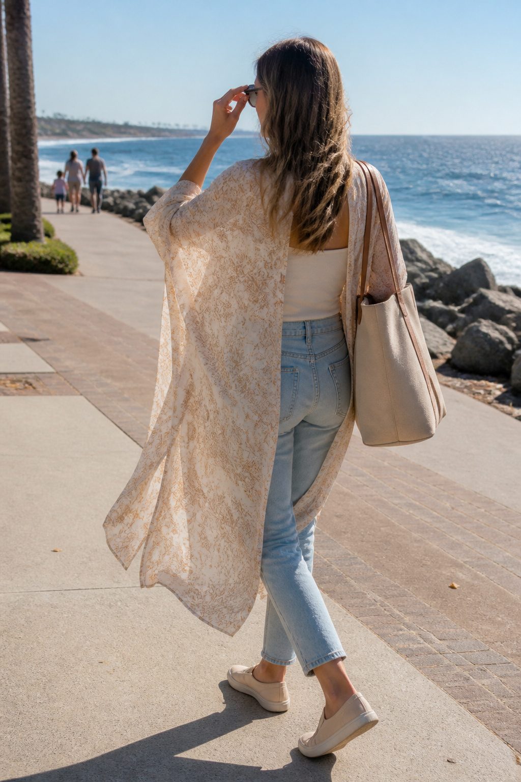 Millennial Mom Outfits: Easy Dressing for Real Days 10 Woman in a neutral tank and kimono walking along a coastal promenade.