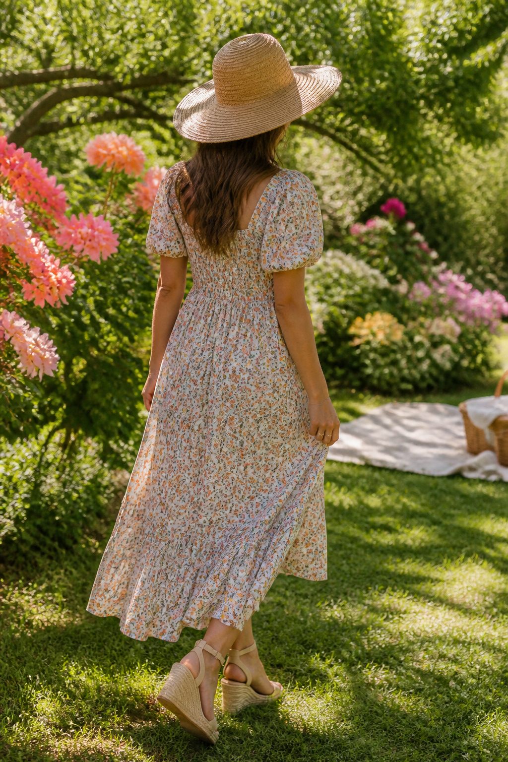 Millennial Mom Outfits: Easy Dressing for Real Days 5 Woman in a print dress and sun hat surrounded by flowers.