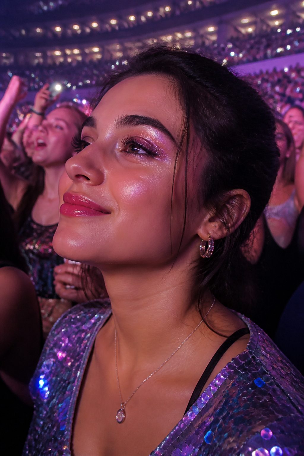 How to Dress for a Pop Concert in 2026 6 A woman with glittery eyeshadow and lipstick enjoys a concert.