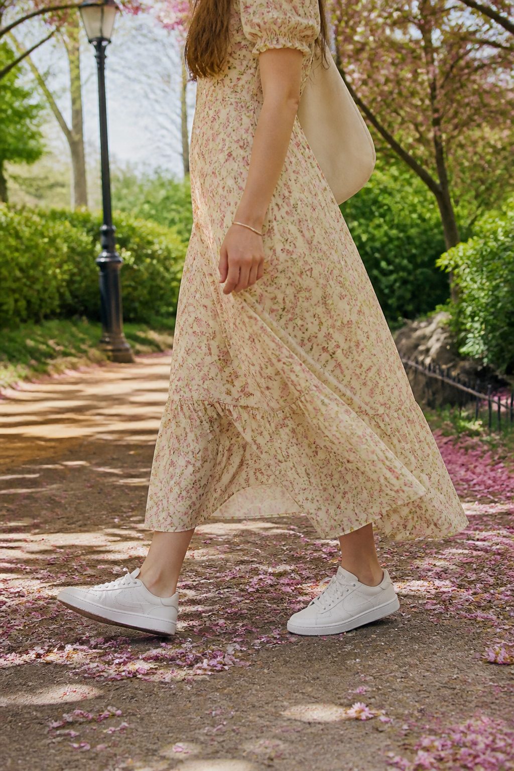 10 Best Sneakers With Dresses for 2026 6 Reebok Club C 85 sneakers alongside a model in a floral dress at a park.