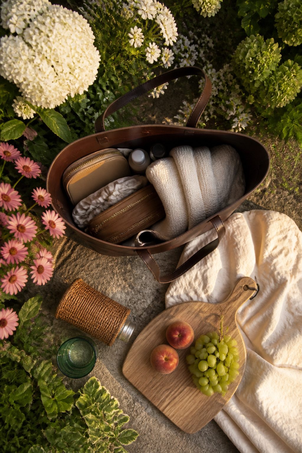 Open-top leather basket bag arranged on a stroller hook.